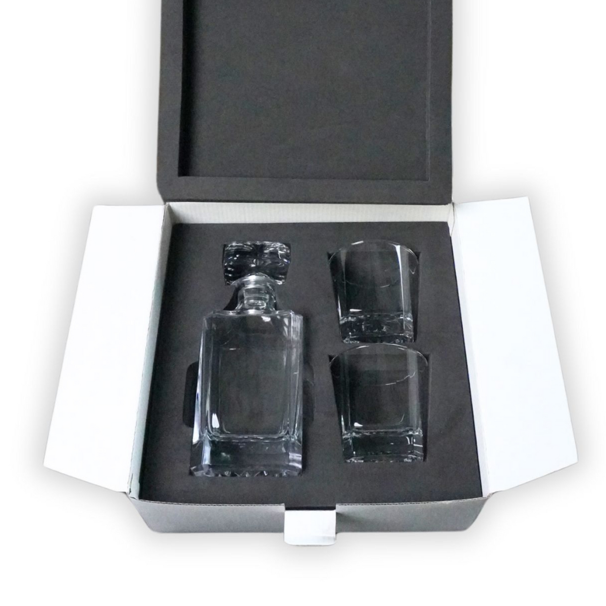 Whiskey decanter with two rocks glasses in a black foam-lined presentation case
