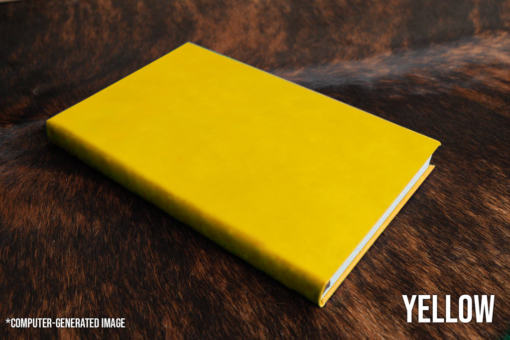 Yellow Premium Leatherette journal cover, shown closed on a cowhide surface